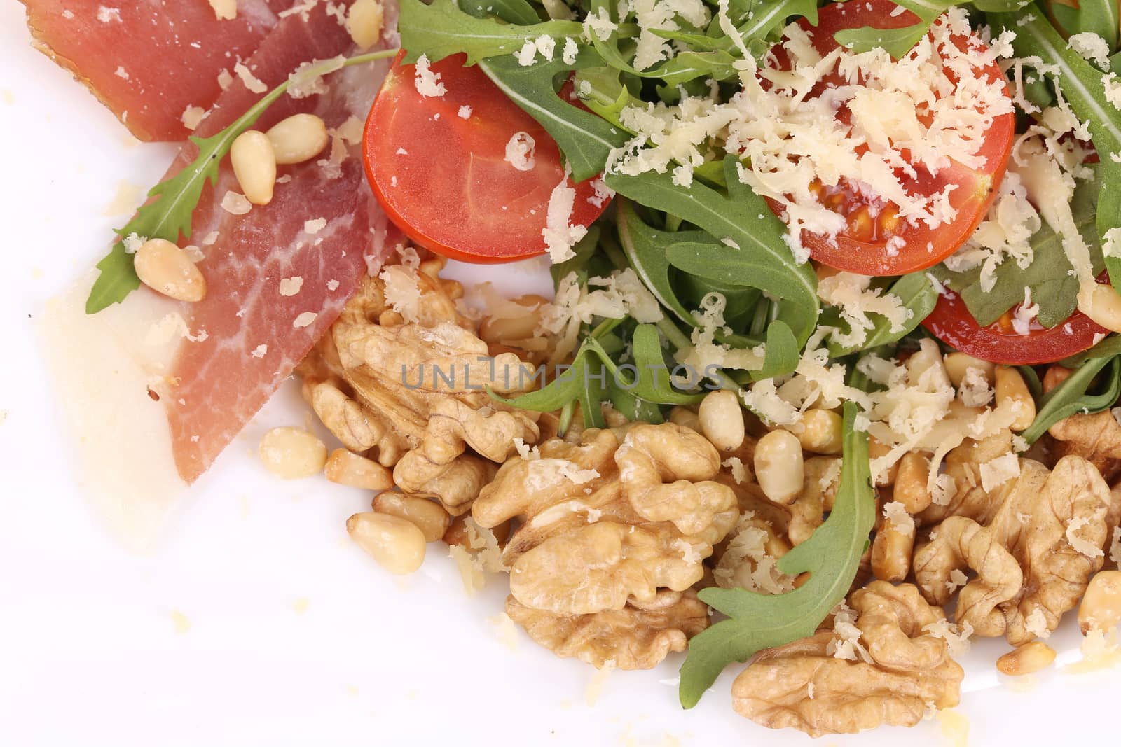 Salad with arugula and prosciutto. Whole background.