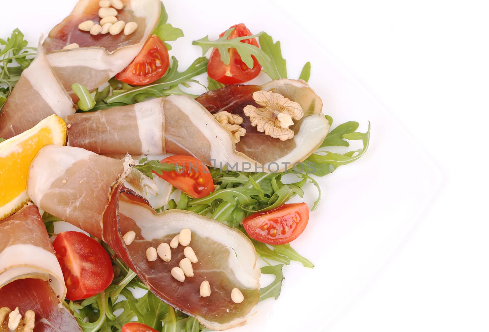 Salad with arugula and prosciutto. Whole background.