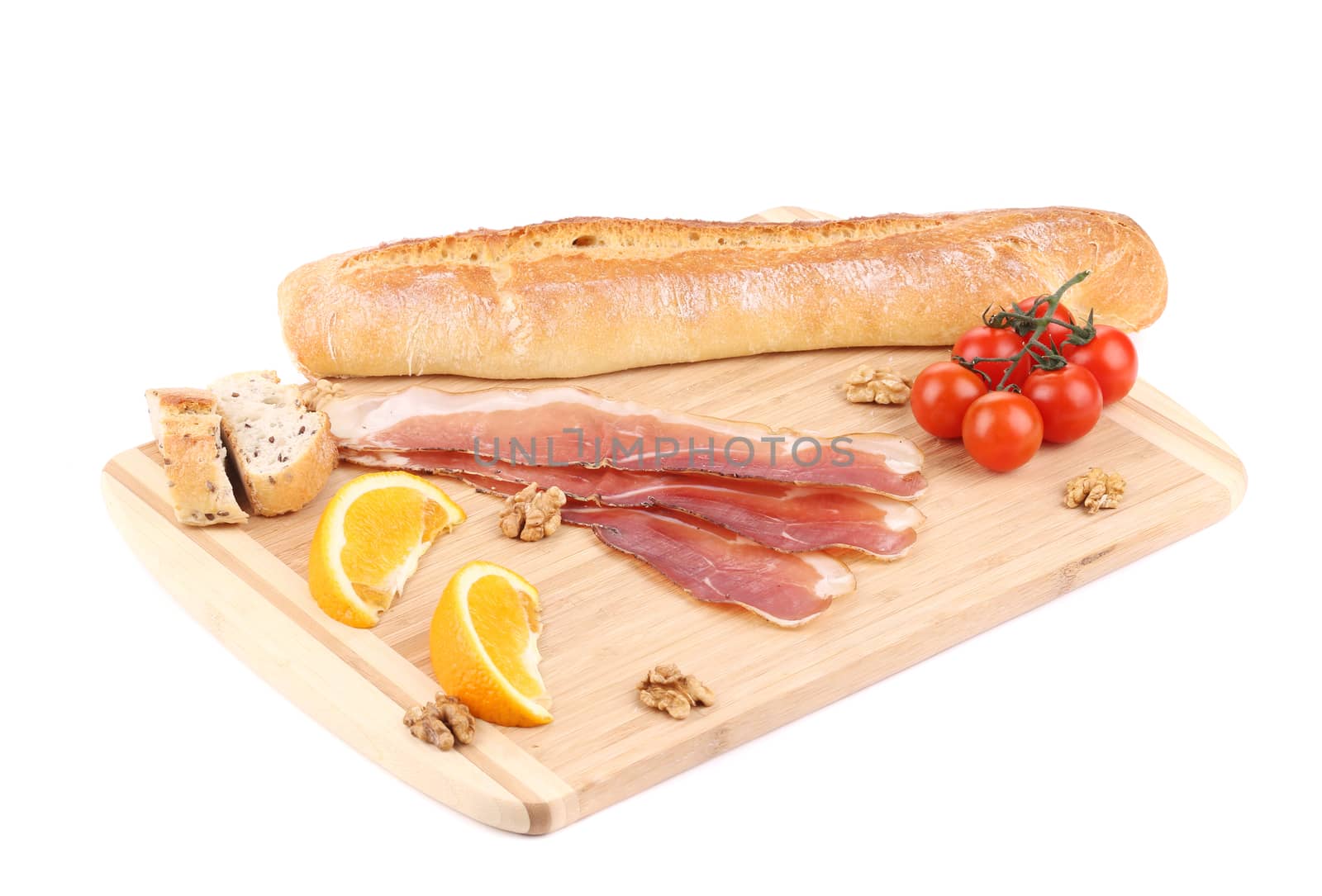 Prosciutto with cherry tomatoes and walnuts. Isolated on a white background.