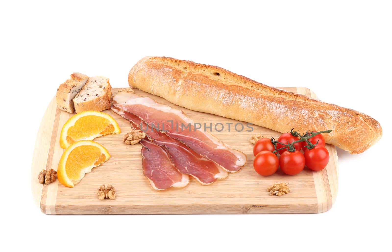 Prosciutto with cherry tomatoes and walnuts. Isolated on a white background.