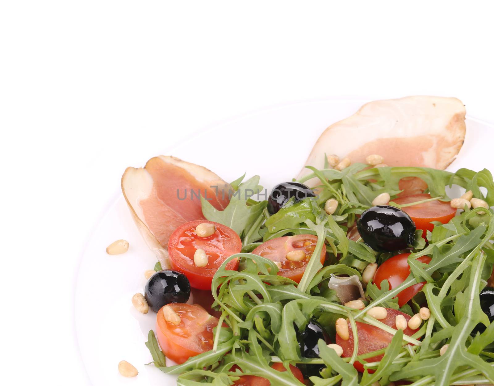 Salad with arugula and prosciutto. Whole background.