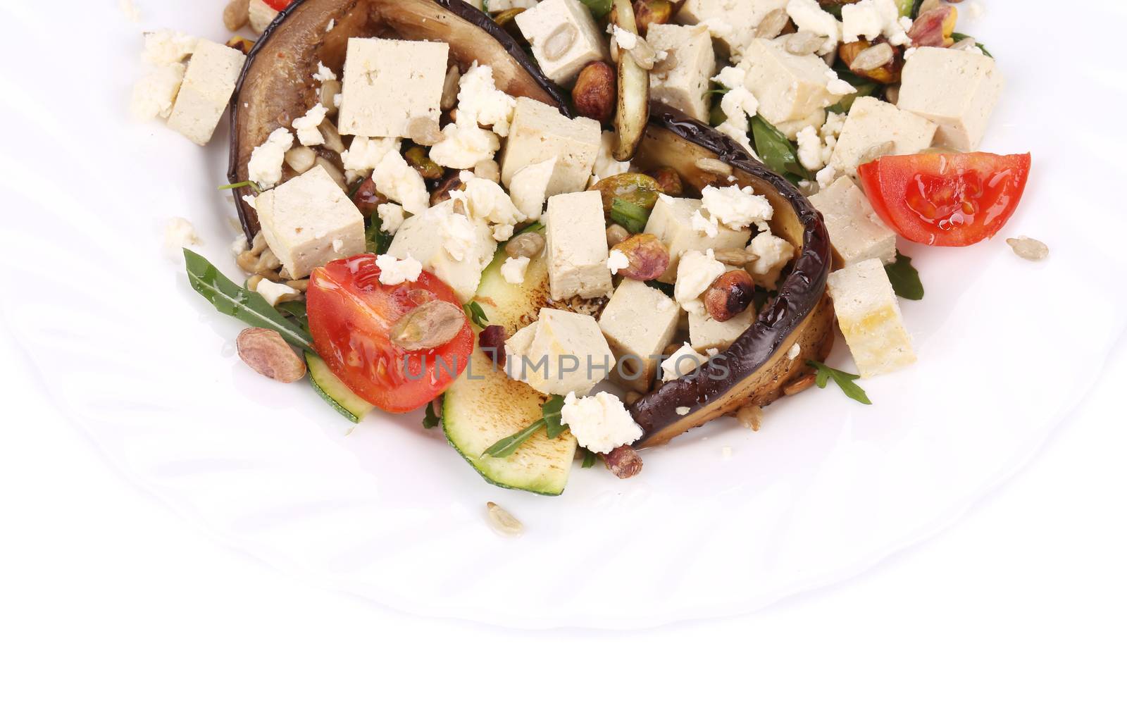 Salad with grilled vegetables and tofu. Isolated on a white background.