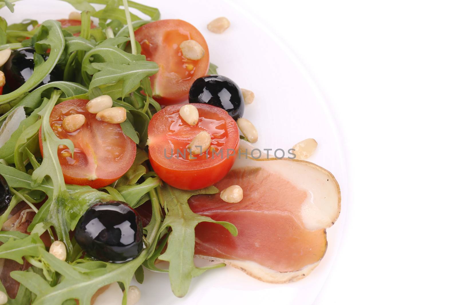 Salad with arugula and prosciutto. Whole background.