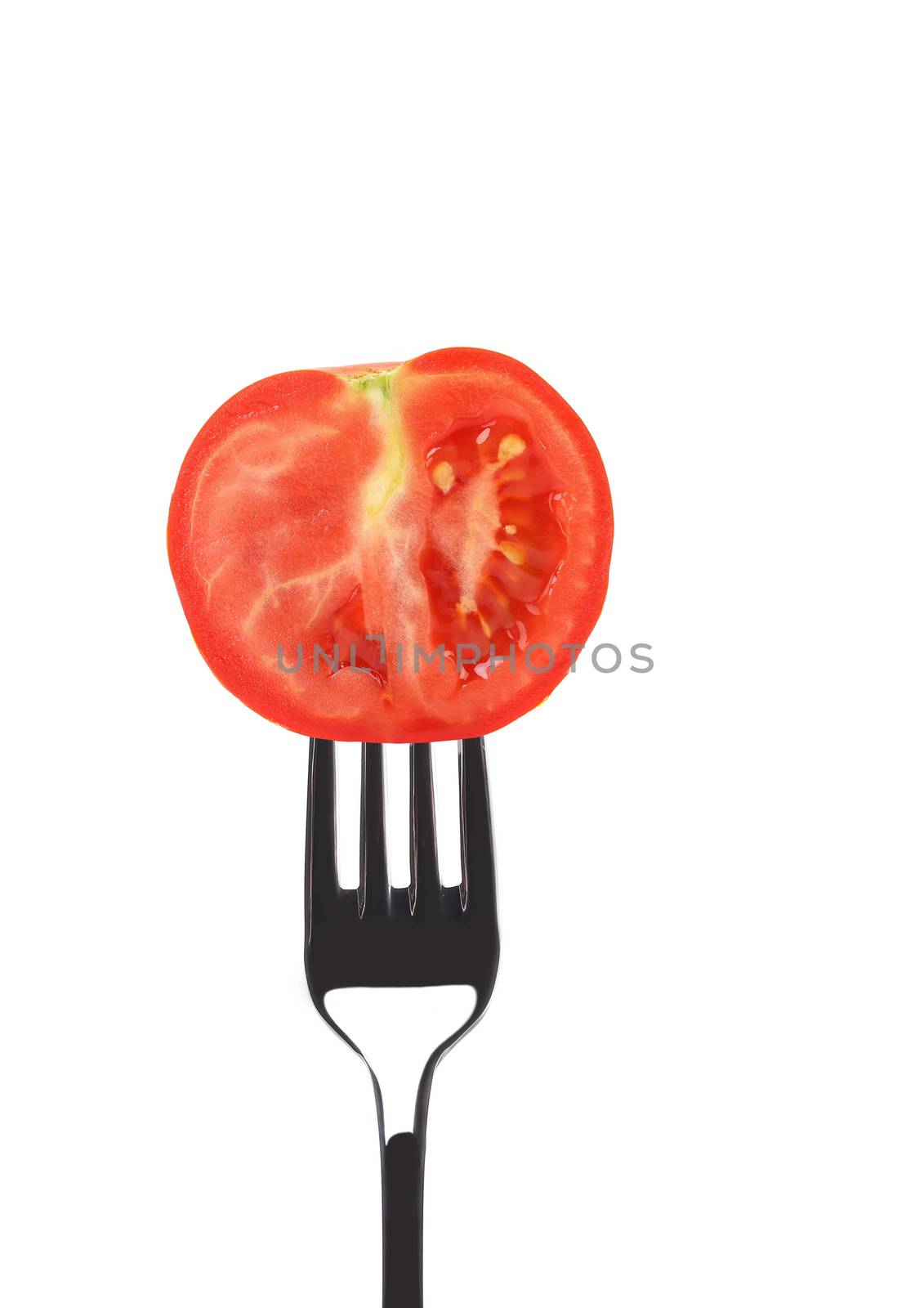 Red ripe tomato on fork. Isolated on a white background.