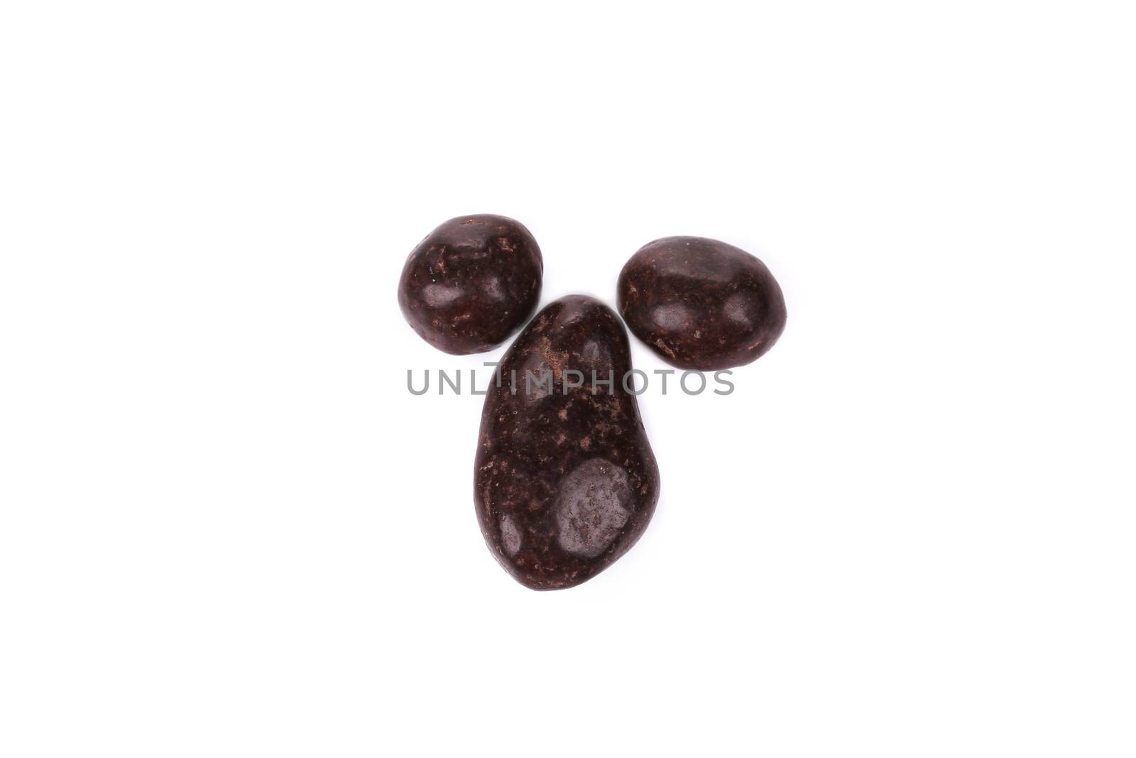 Dark chocolate dragee. Isolated on a white background.