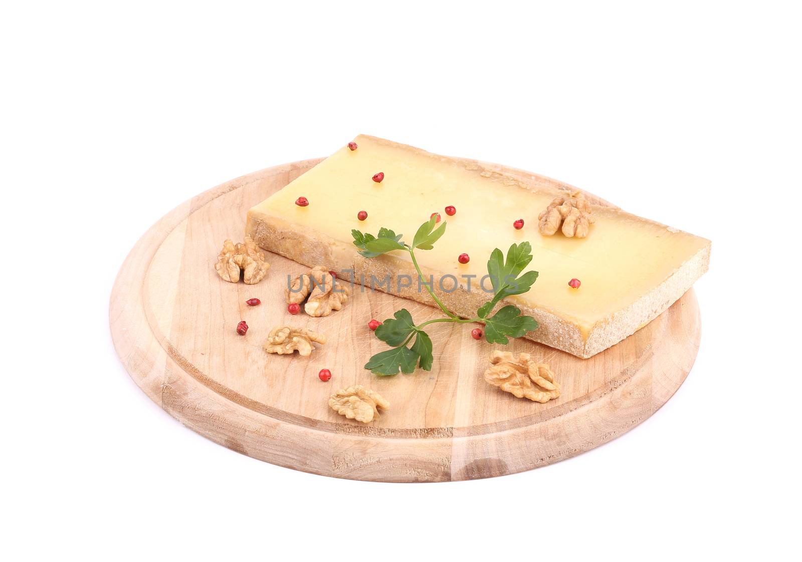 Parmesan cheese on platter with walnuts. Isolated on a white background.