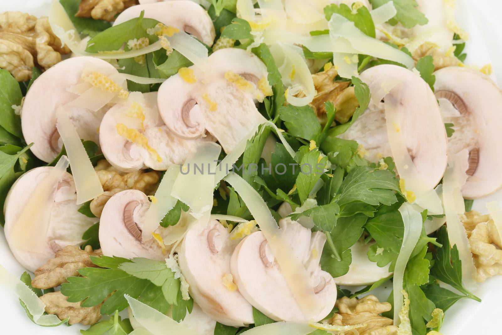 Mushroom salad with walnuts and parsley. Isolated on a white background.