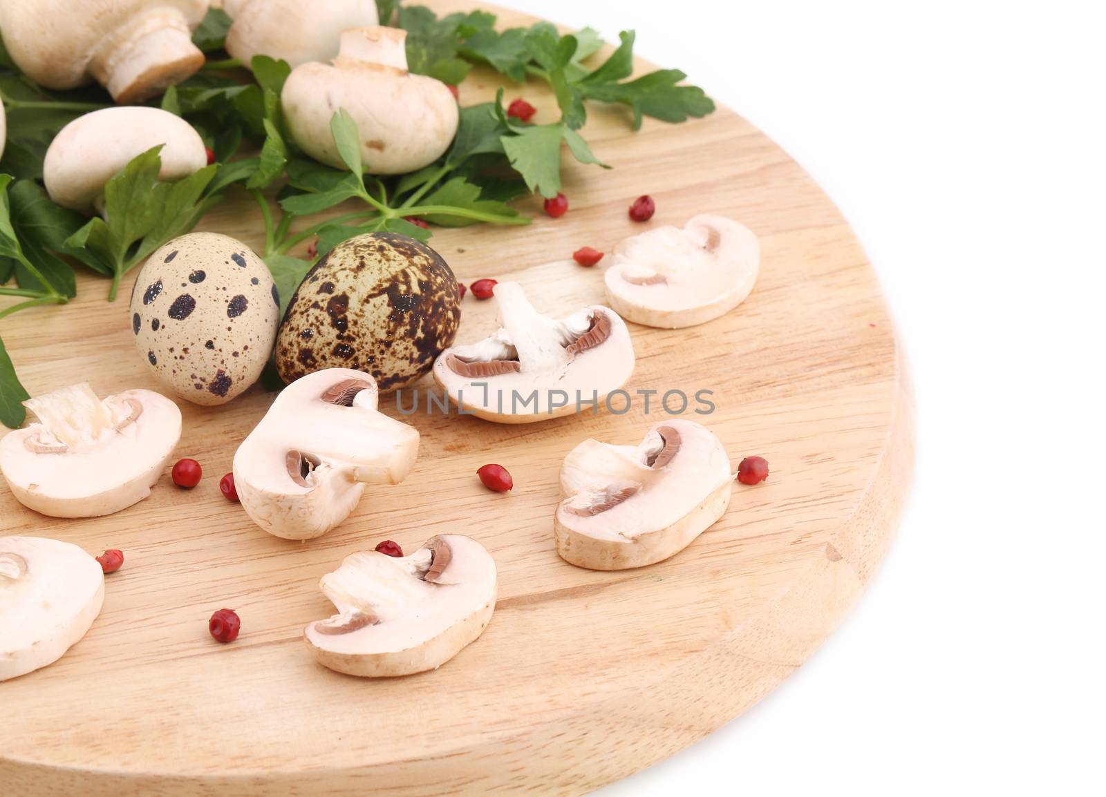 Mushrooms champignon and quail eggs on platter. Isolated on a white background.