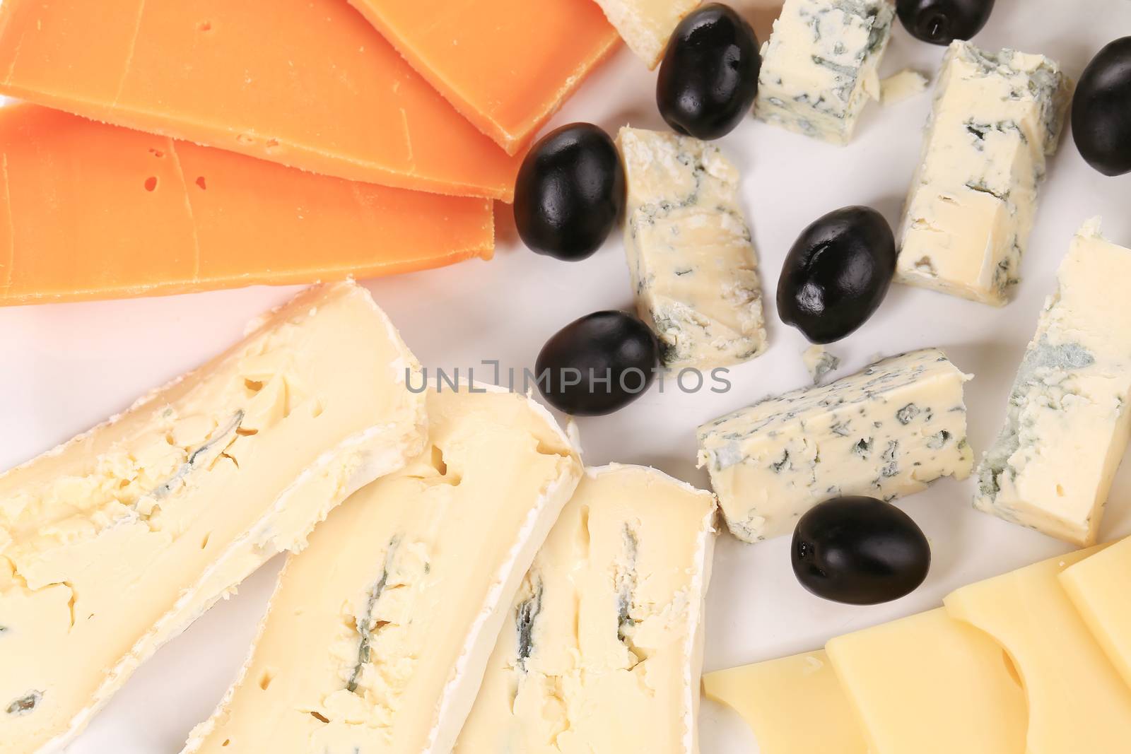 Cheese plate with black olives. by indigolotos