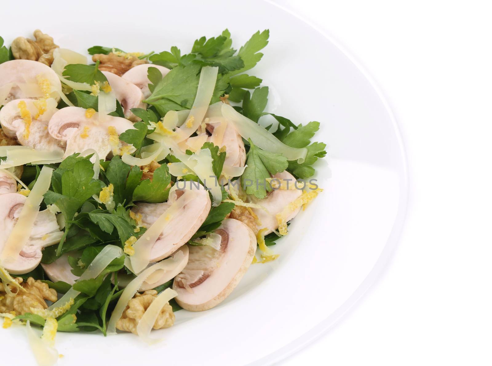 Mushroom salad with walnuts and parsley. Isolated on a white background.