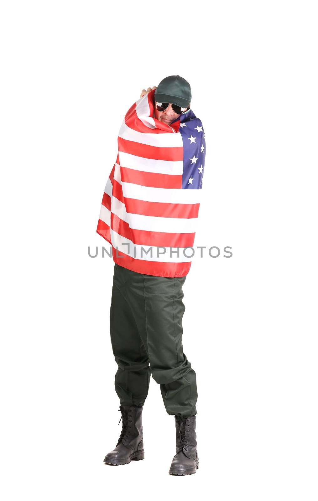 Man in workwear stands with american flag. by indigolotos