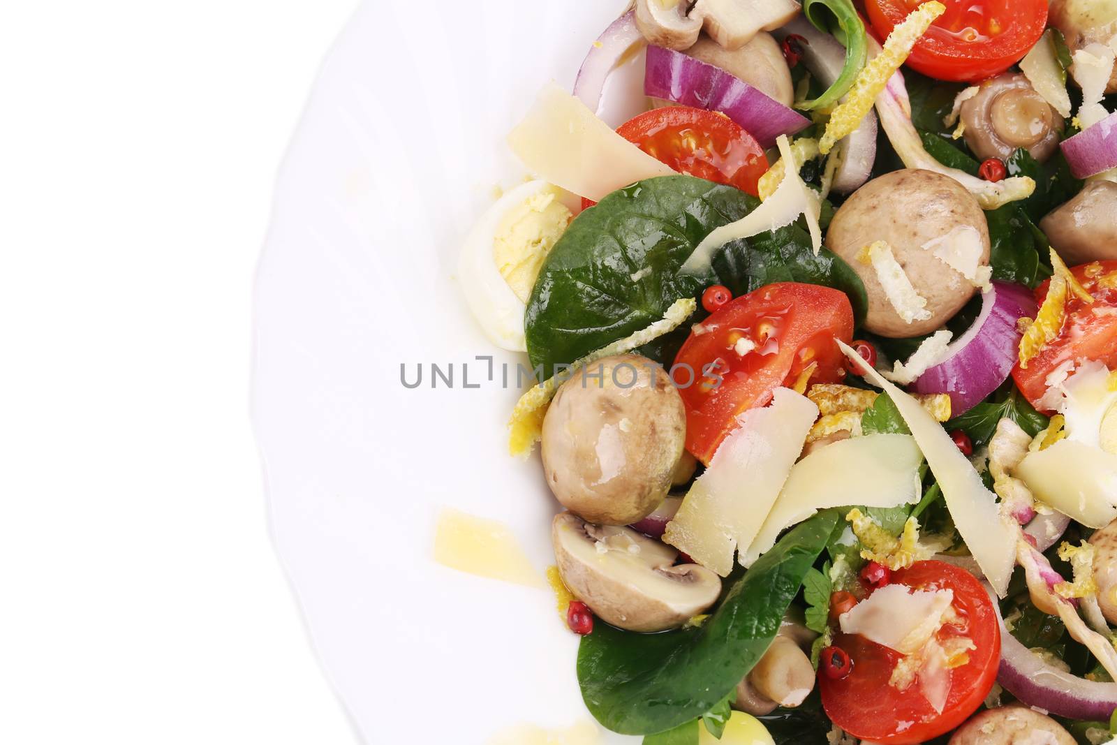 Mushroom salad with tomatoes and quail eggs. Isolated on a white background.