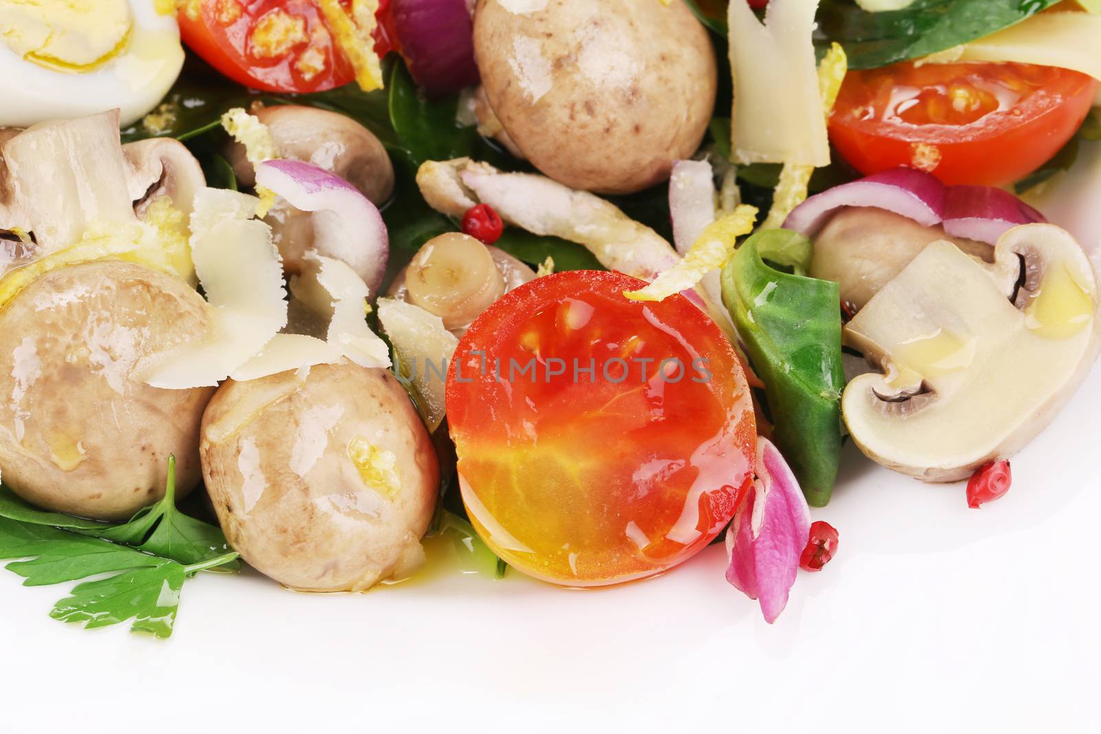 Mushroom salad with tomatoes and quail eggs. Isolated on a white background.