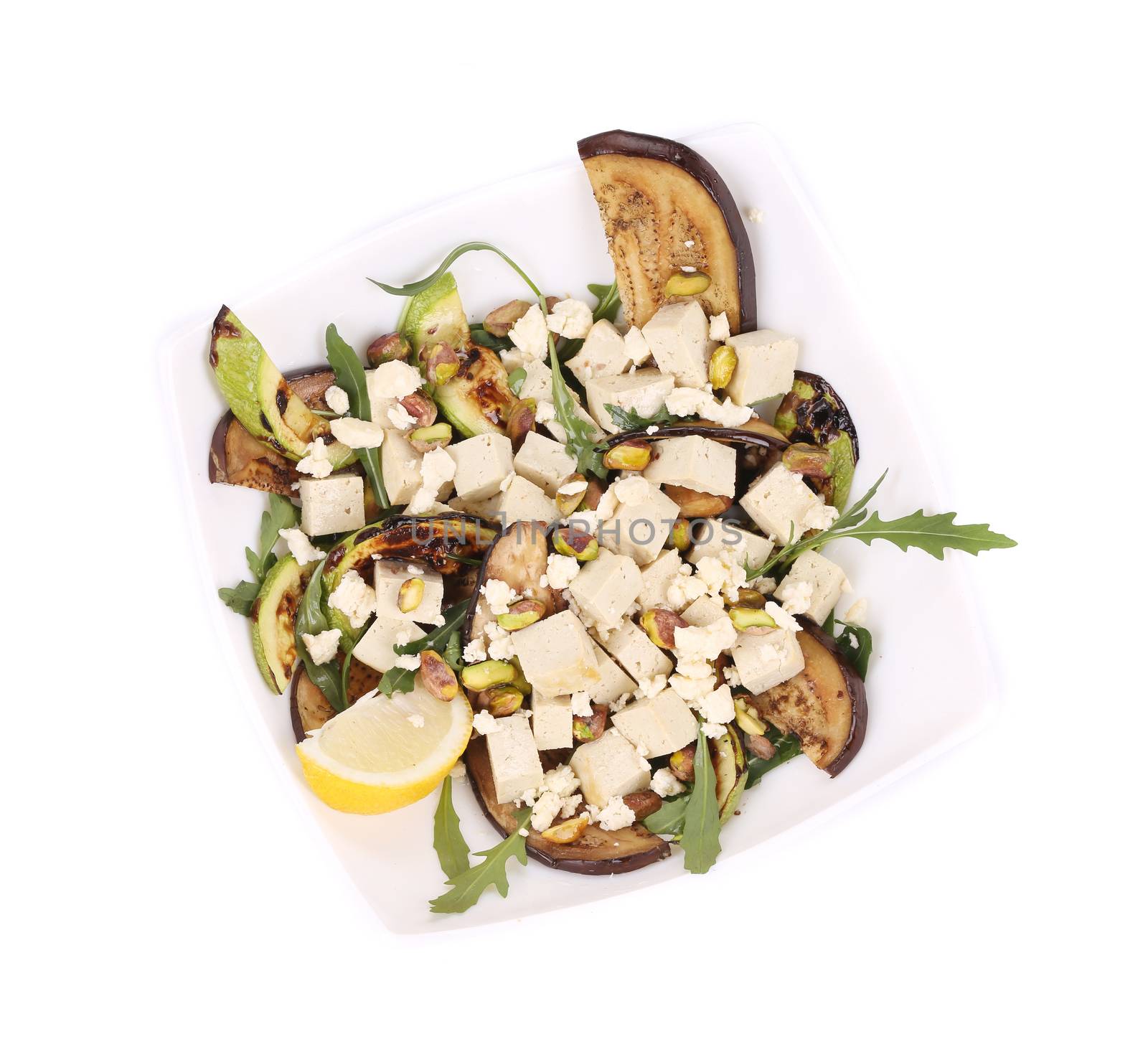 Salad with grilled vegetables and tofu. Isolated on a white background.