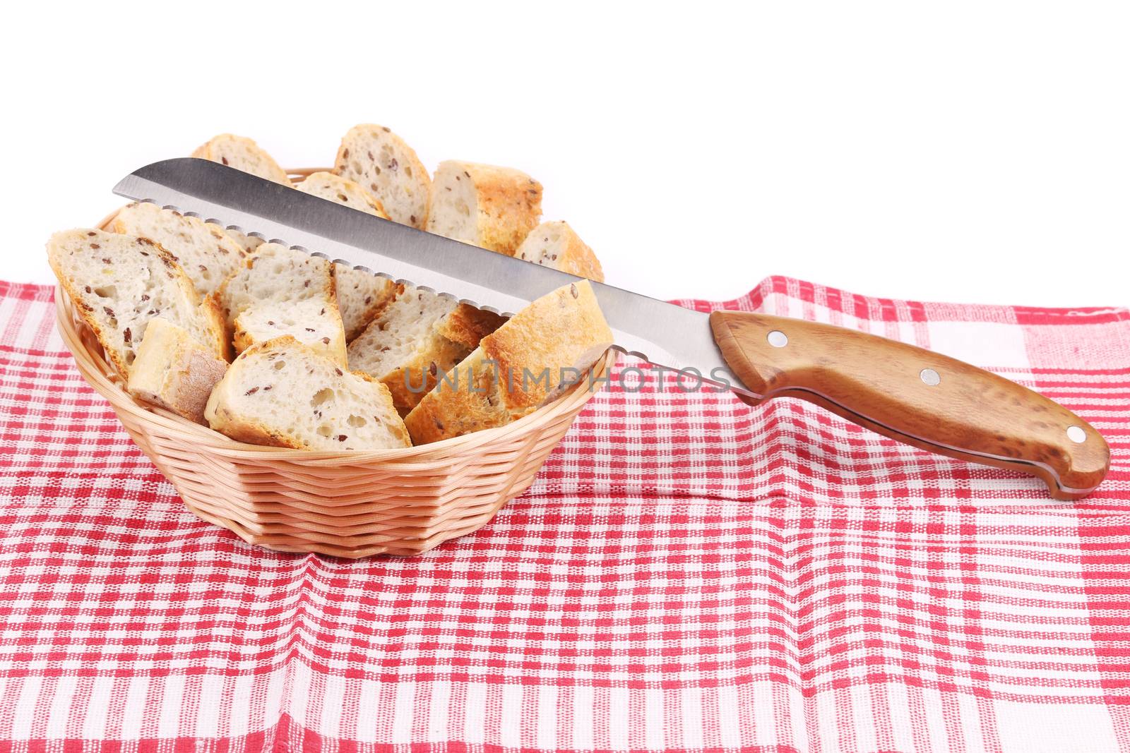 Basket with sliced bread and knife. by indigolotos