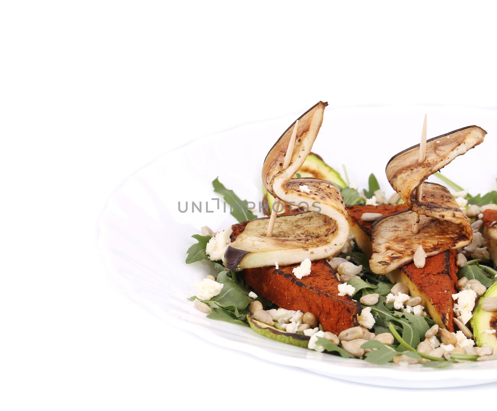 Salad with grilled vegetables and tofu. Isolated on a white background.