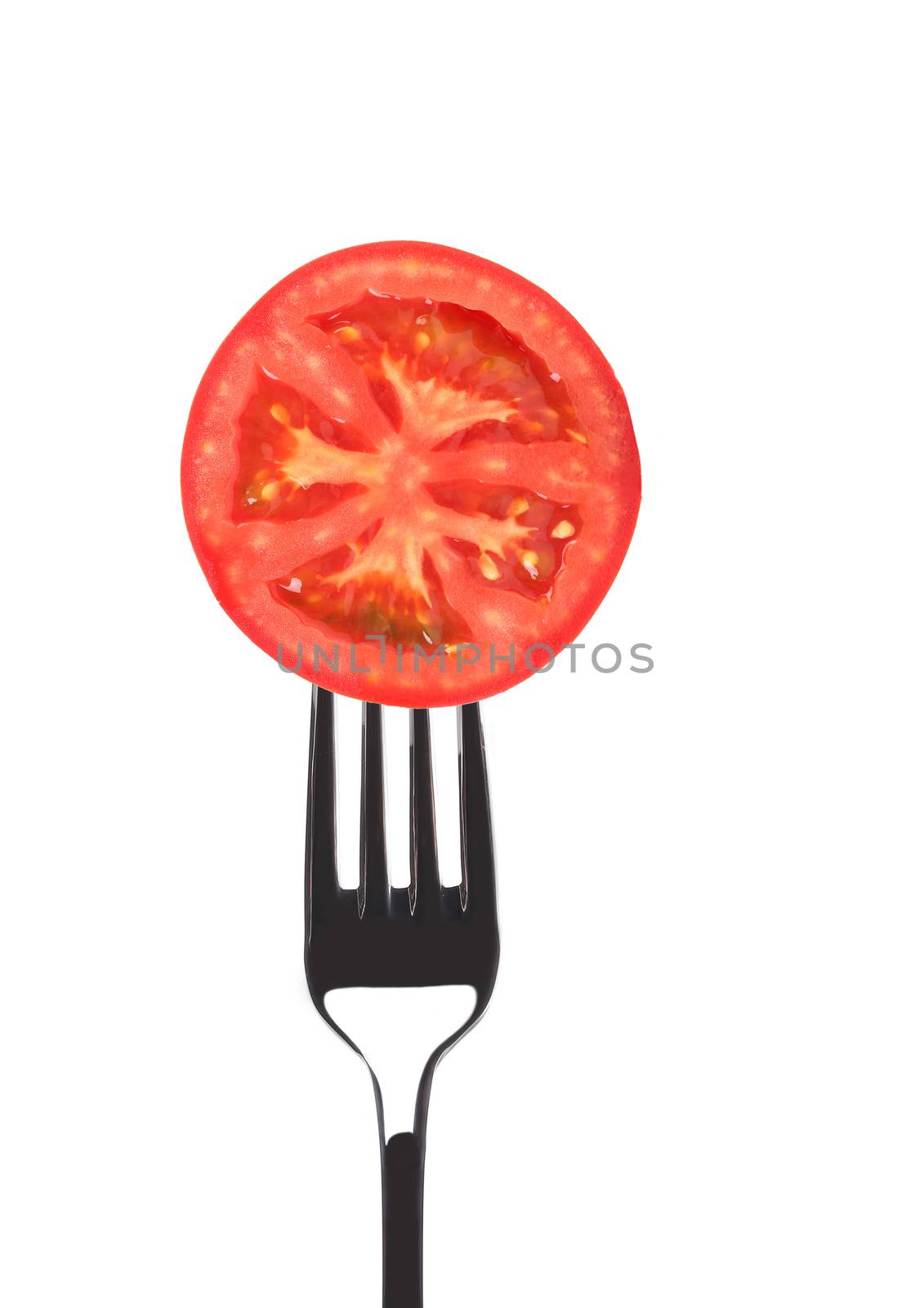 Red juicy tomato on fork. by indigolotos
