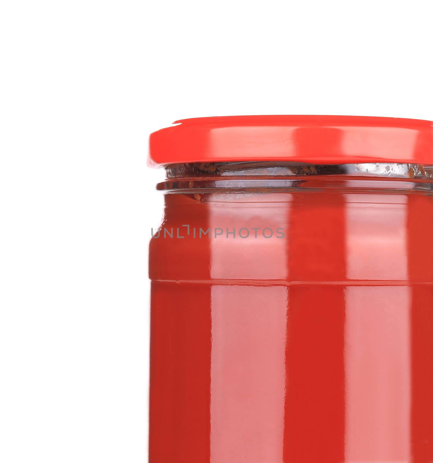 Glass jar with tomato sauce. Isolated on a white background.