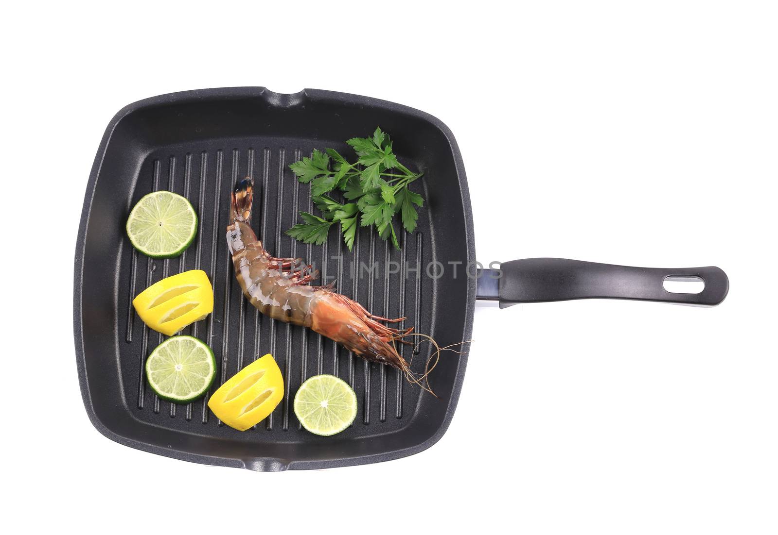 Frying pan with shrimp and lemon slices. Isolated on a white background.