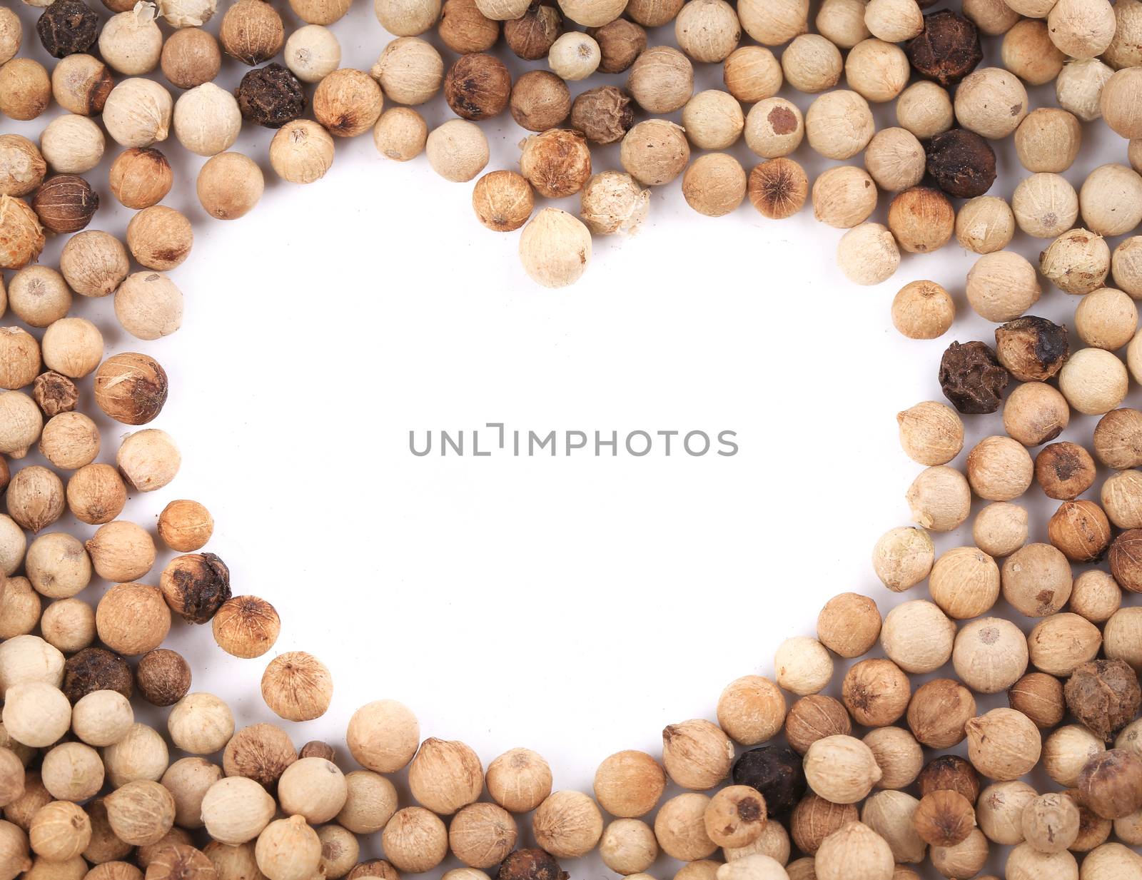 White peppercorn in shape of heart. by indigolotos