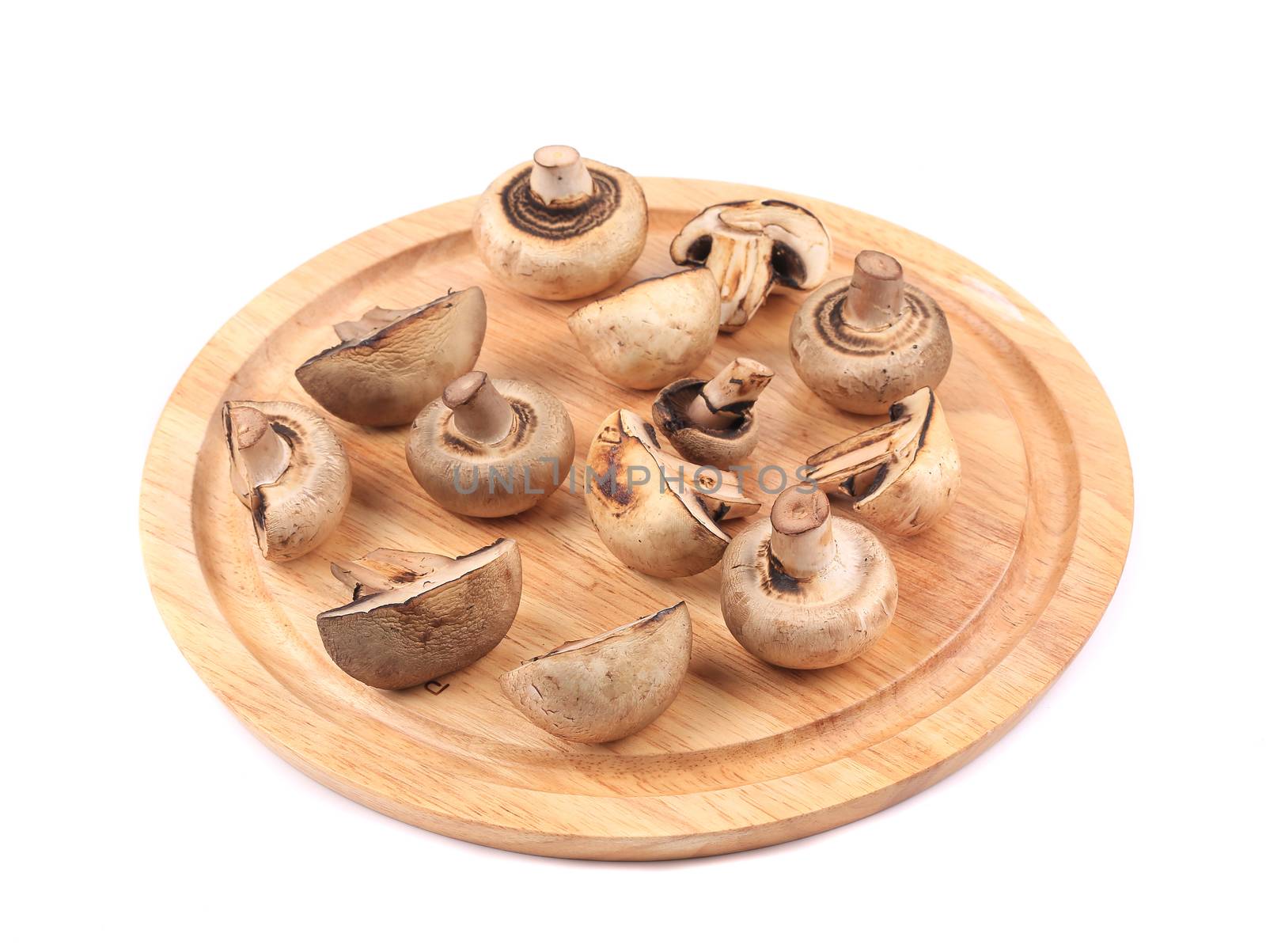 Mushrooms on wooden platter. by indigolotos