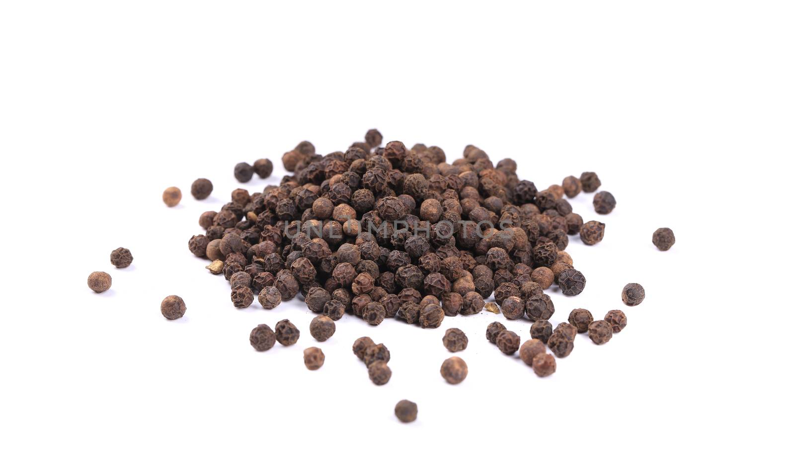 Heap of black spicy peppercorn. by indigolotos