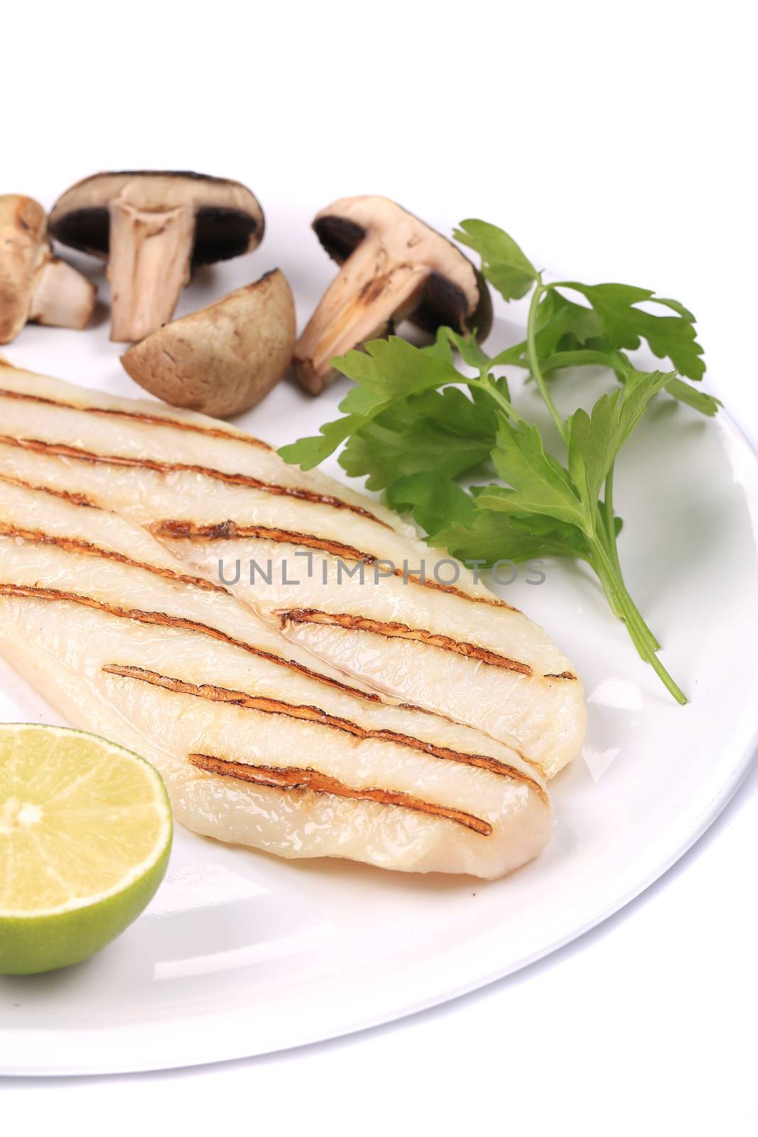 Grilled fish fillet with mushrooms. Isolated on a white background.