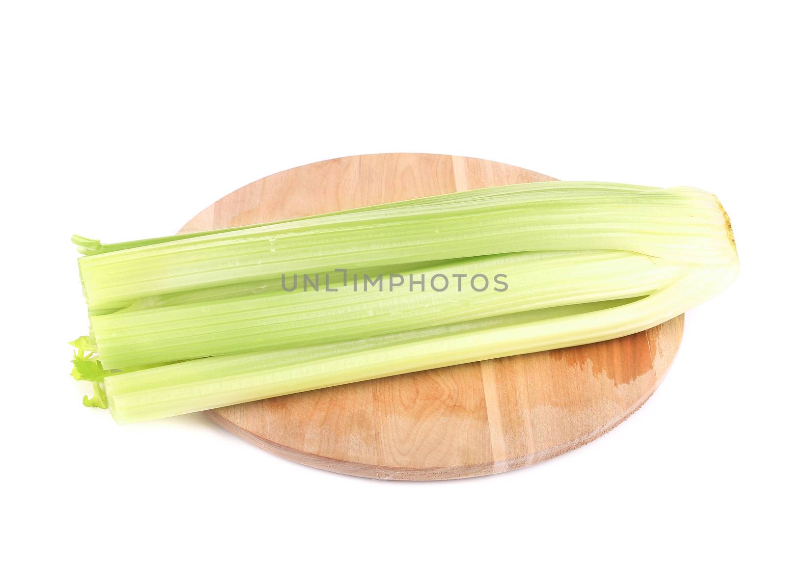 Fresh celery on wooden platter. Isolated on a white background.