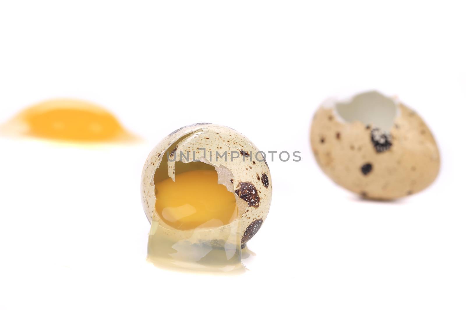 Broken quail eggs. Isolated on a white background.