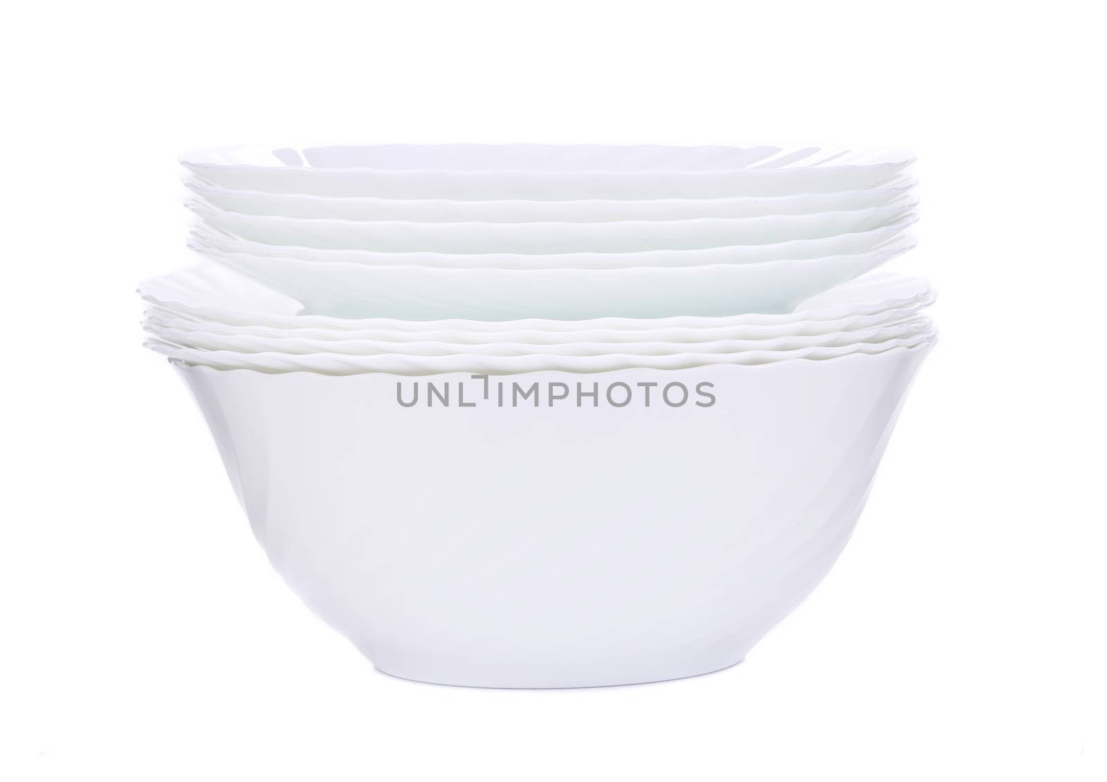 Stack of new clean white plates. Isolated on a white background.