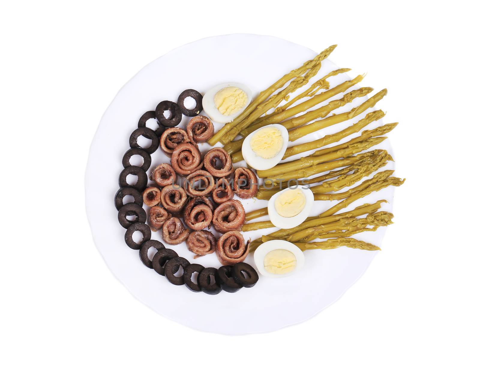 Asparagus salad with anchovies. Isolated on a white background.