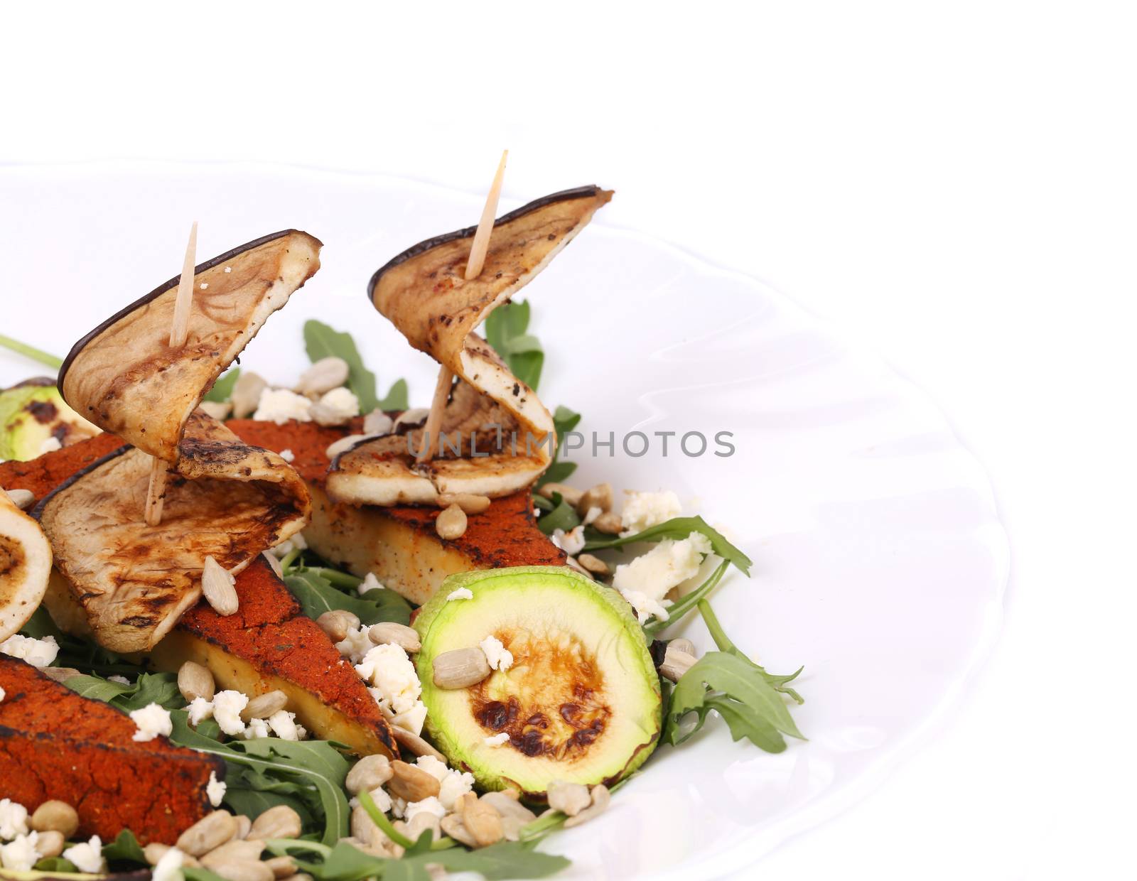 Salad with grilled vegetables and tofu. Isolated on a white background.