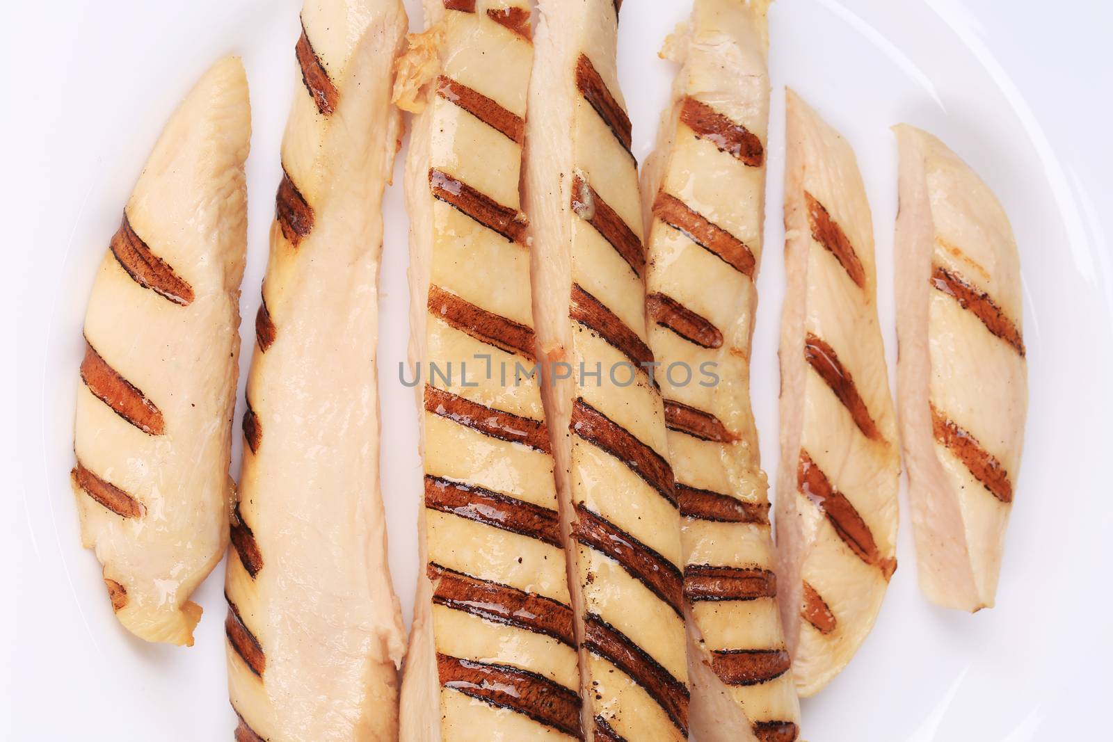 Beautiful grilled chicken fillet. Isolated on a white background.