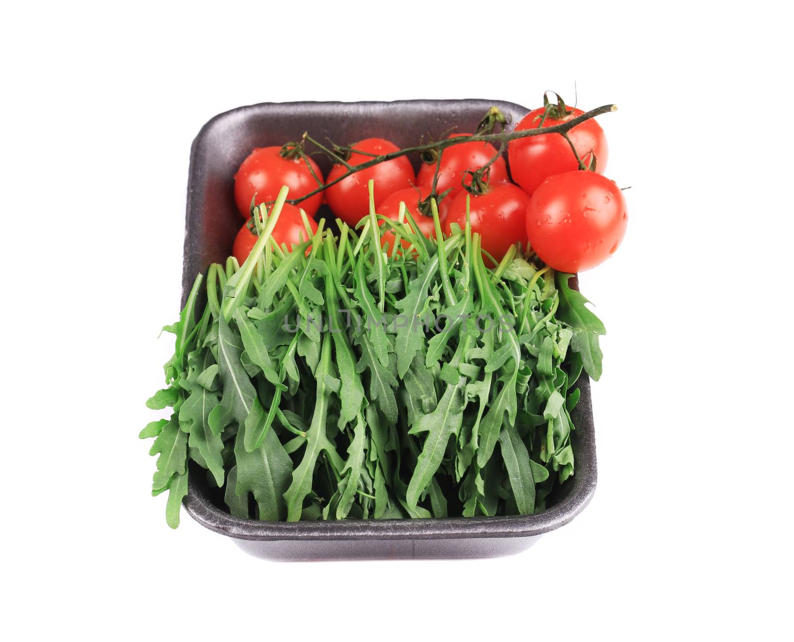 Fresh arugula and juicy tomatoes. Isolated on a white background.