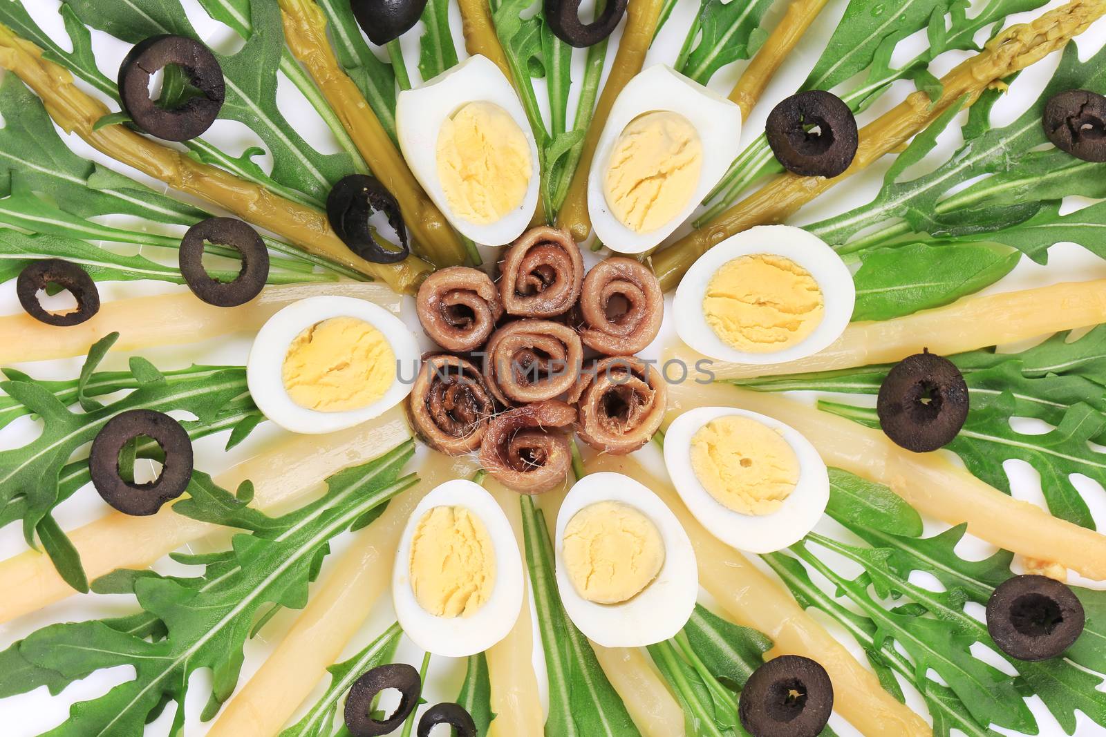 Asparagus salad with anchovies black olives and eggs.