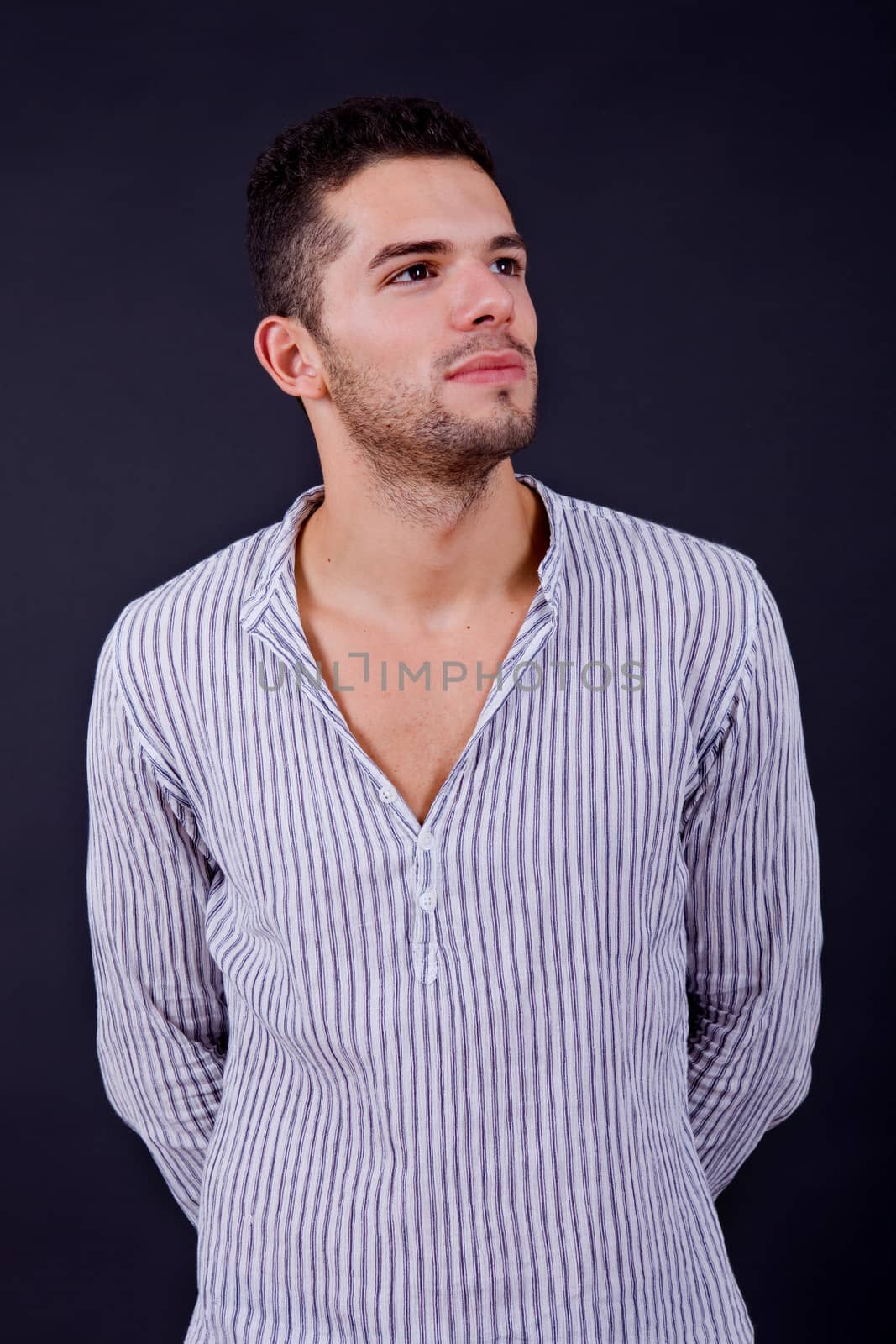 young casual man portrait on a black background