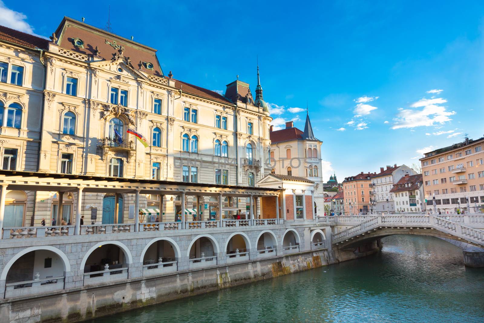 Ljubljana, Slovenia, Europe - Ljubljanica River, Triple bridge - Tromostovje and Central Market designed by famous architect Joze Plecnik shot in sunset.