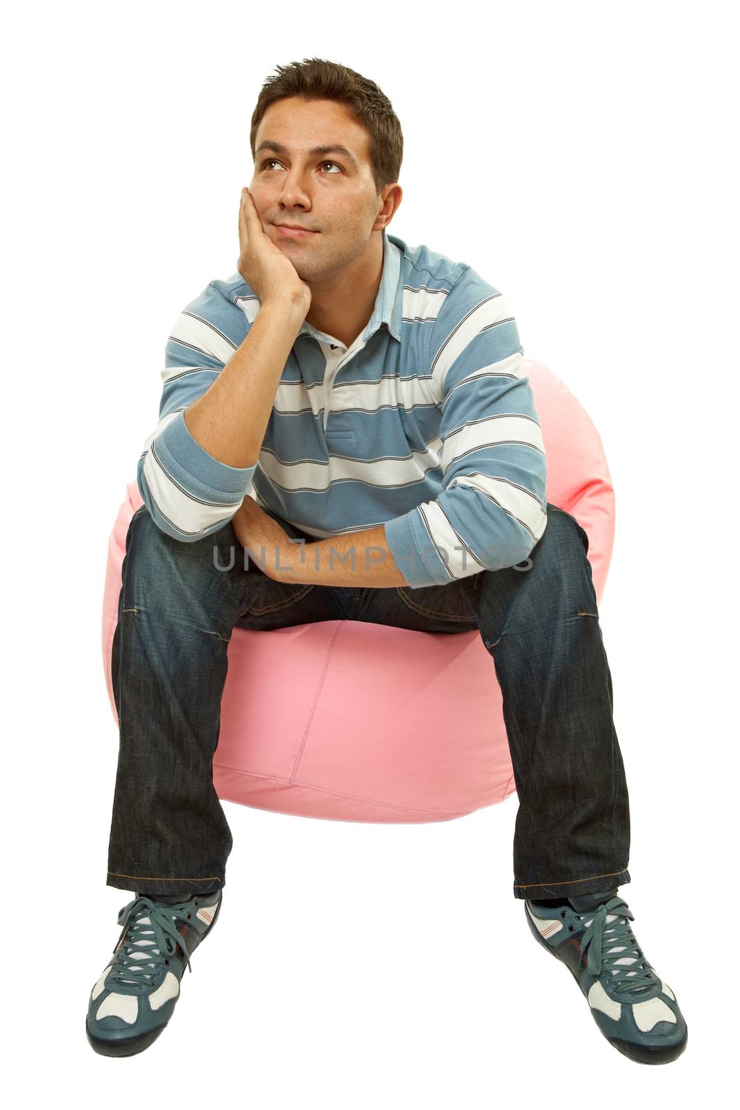 young casual man seated in a small sofa