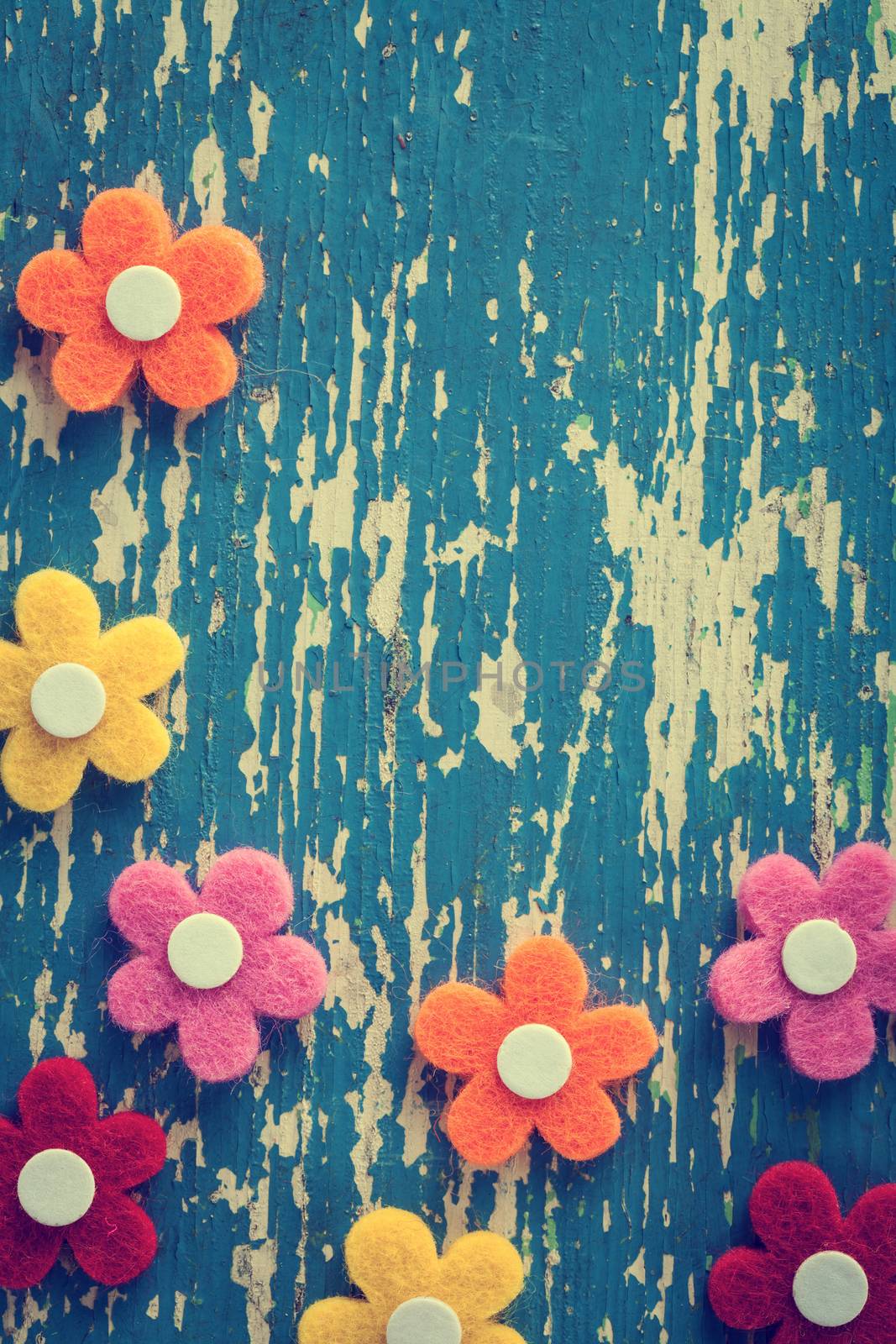 Spring felt flowers on wood background. Top view. Instagram filter