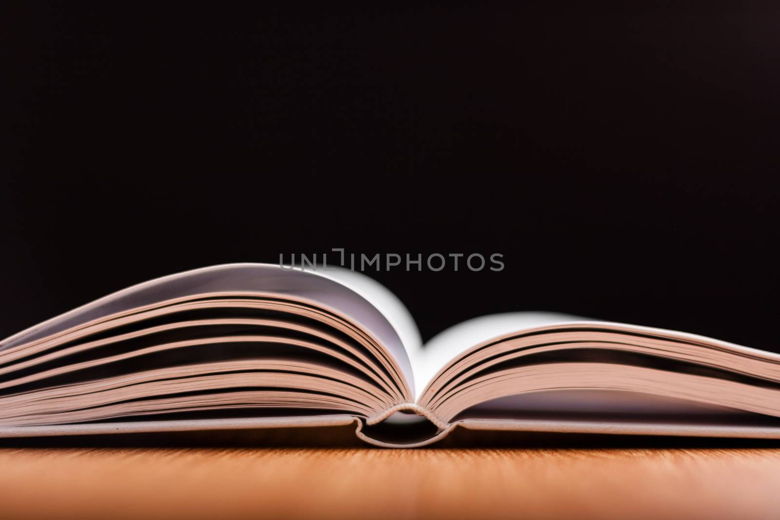 open book with white pages on wooden table