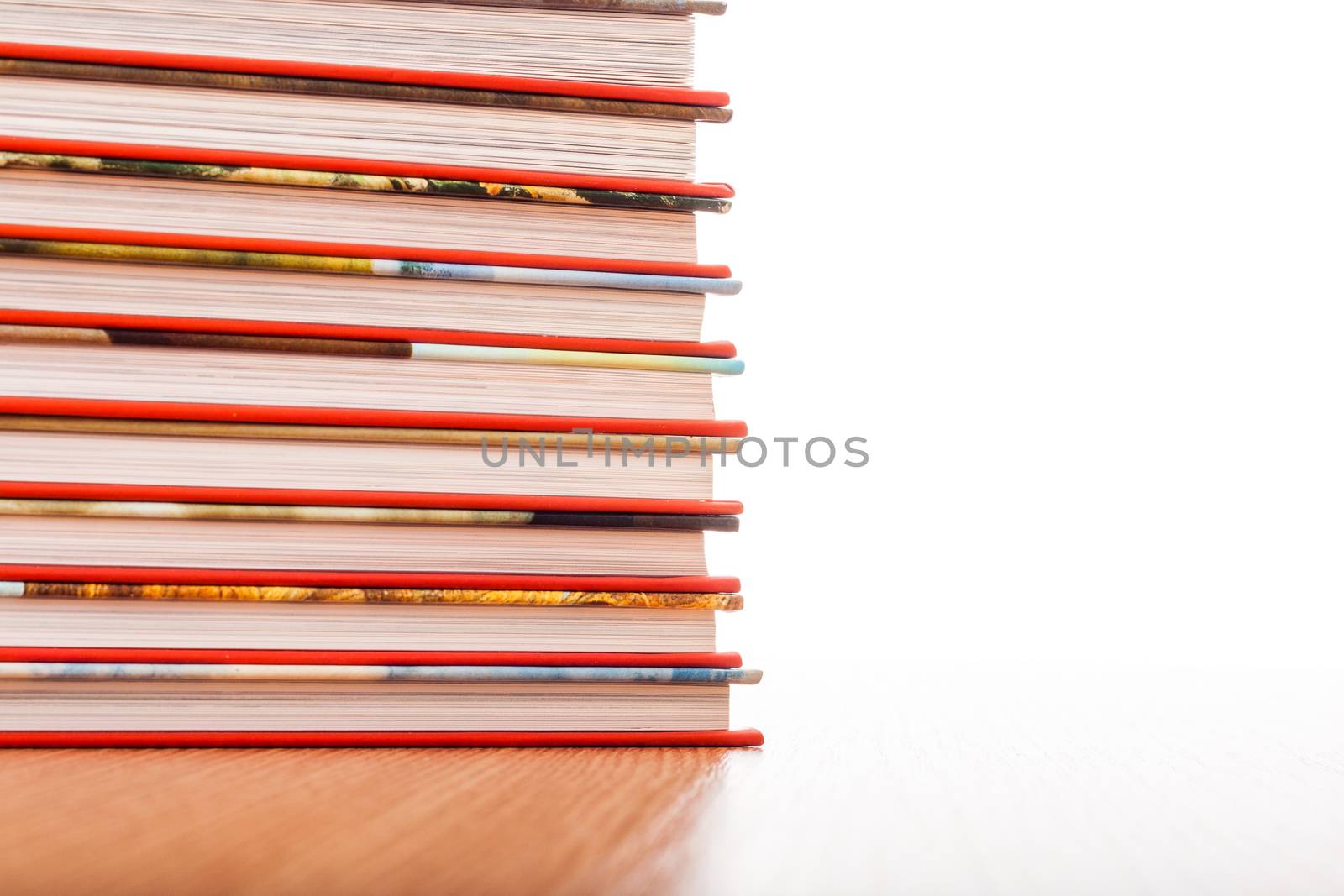 Pile of different books put on a wooden table