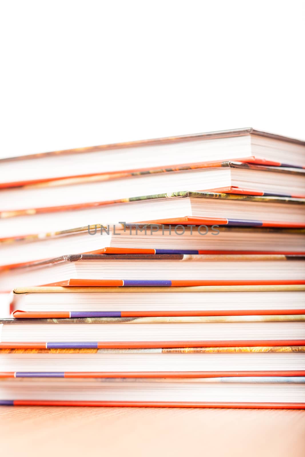 Pile of different books put on a wooden table