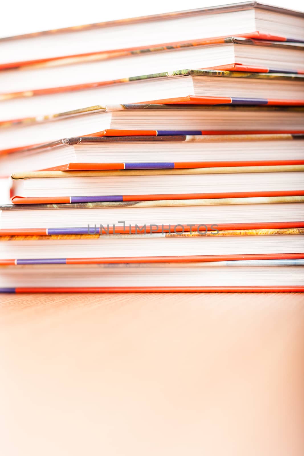 Pile of different books put on a wooden table