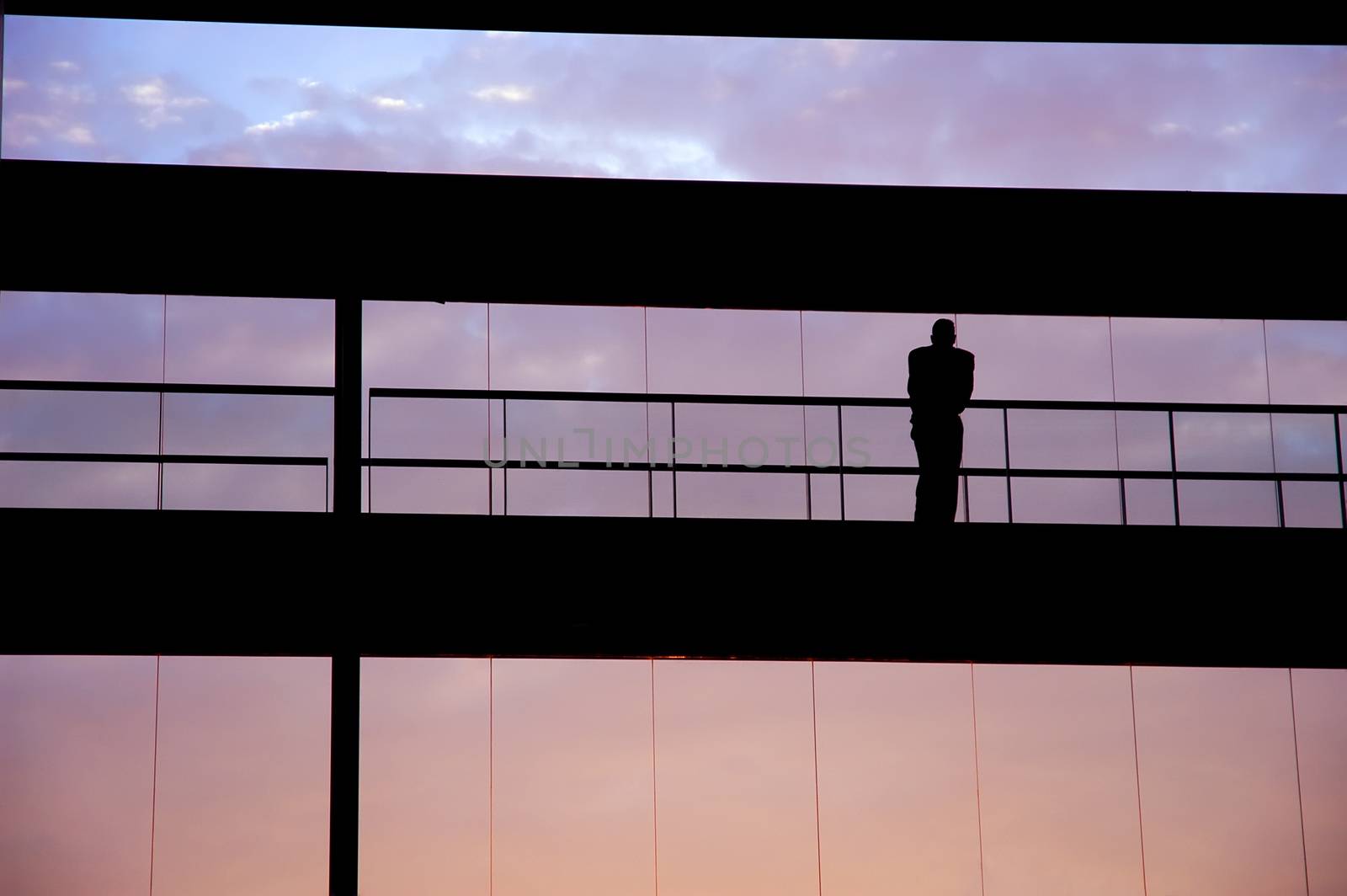 worker inside the building silhouette at sunset