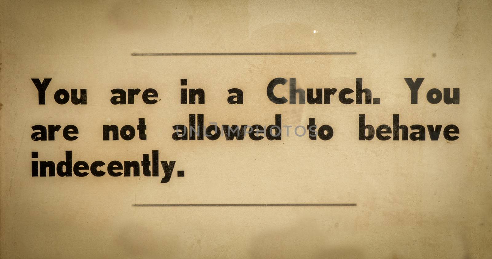 Old VIntage Sign In A Church Asking Visitors To Behave Respectfully