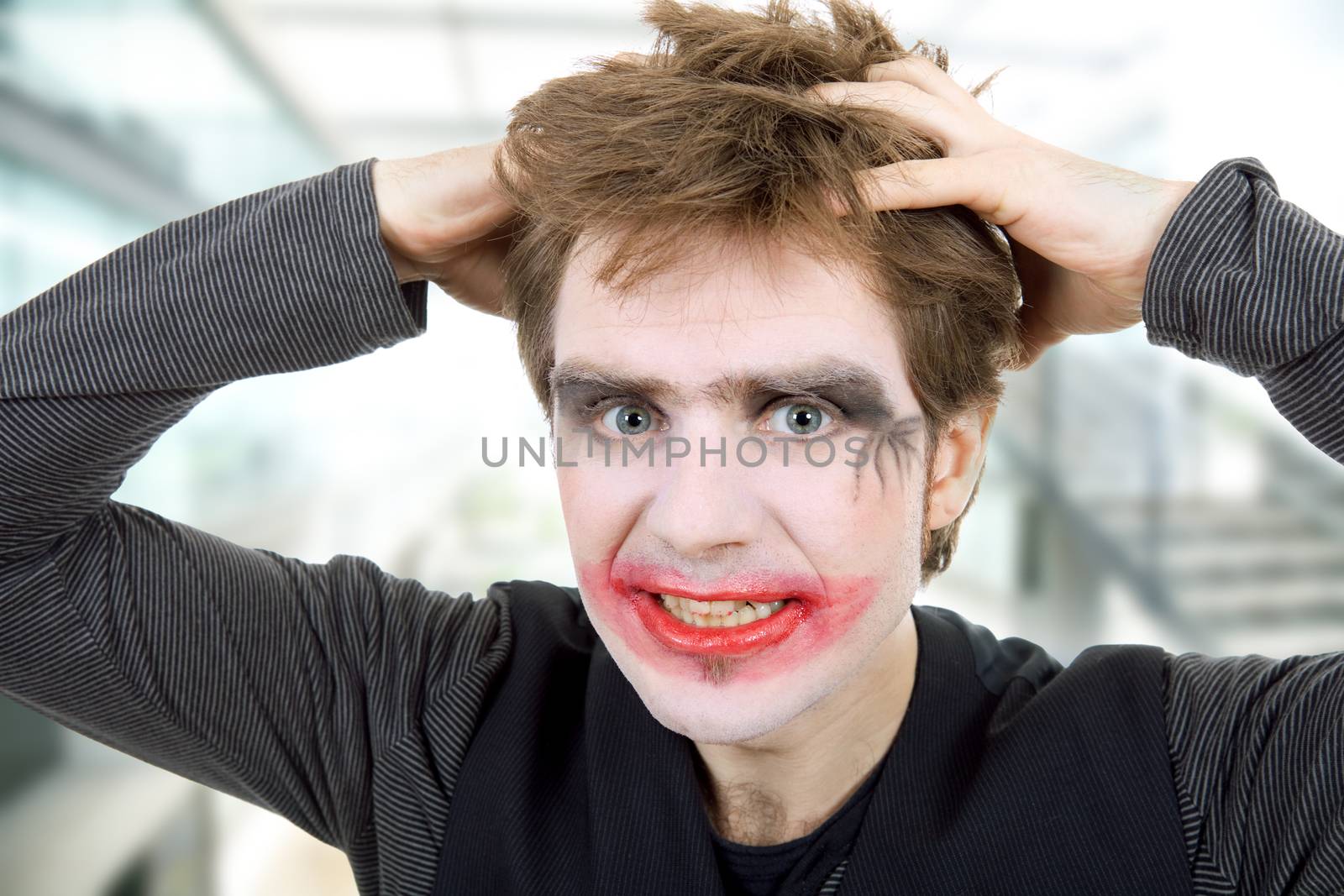 crazy young man dressed as joker