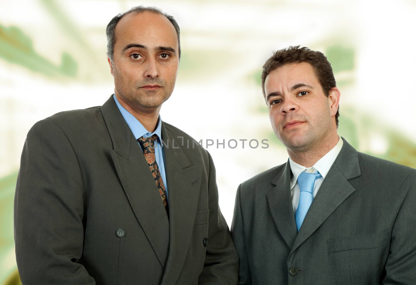 two business men portrait in a office building