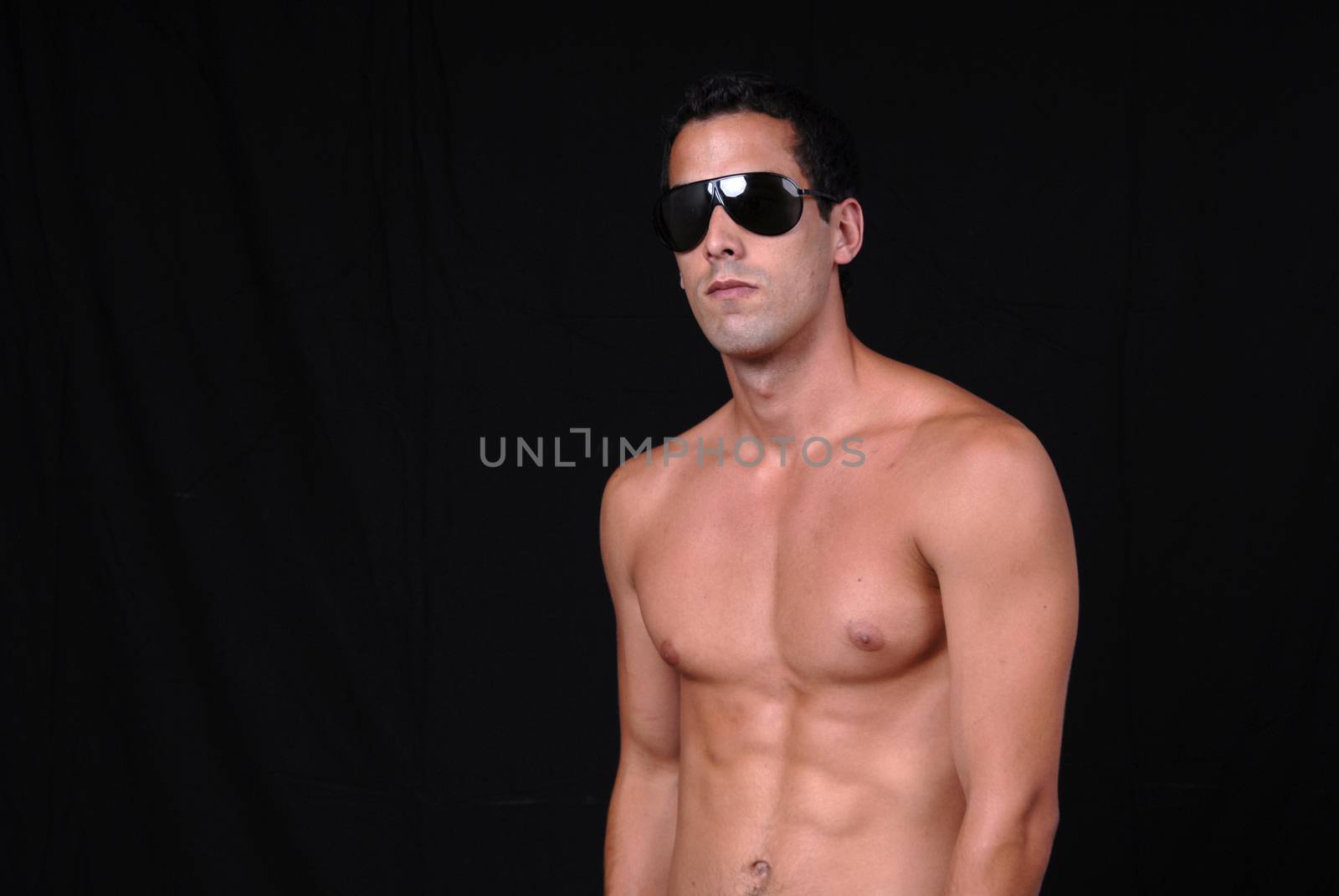 naked muscular male model with sun glasses