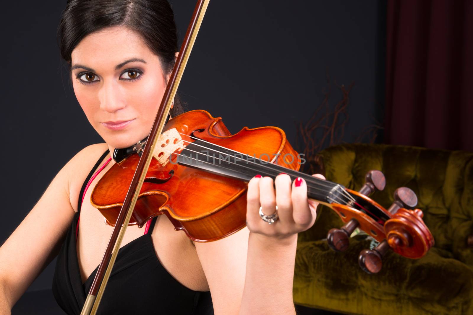 Close intimate portrait of beautiful woman violin music player