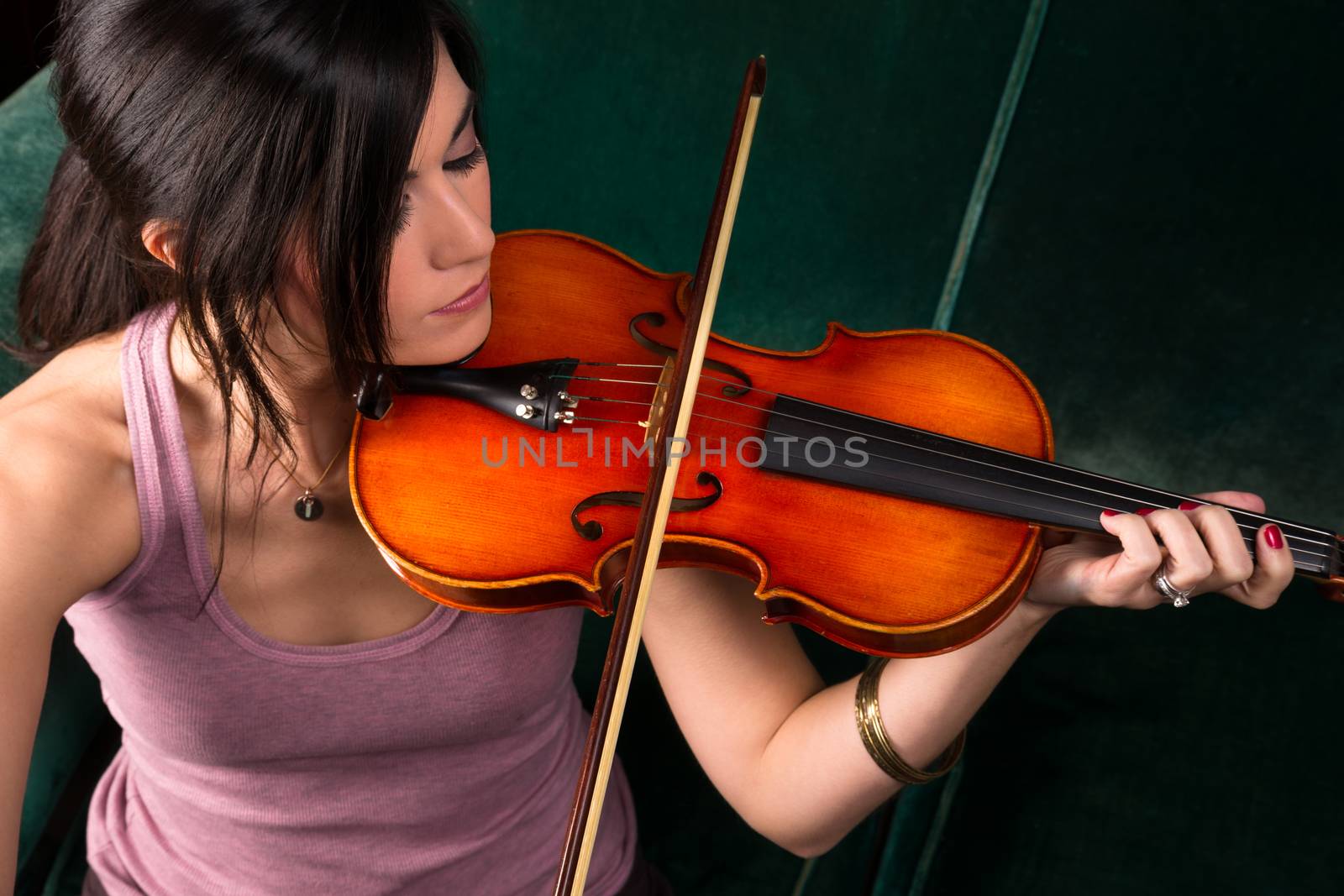 Close intimate portrait of beautiful violin music player